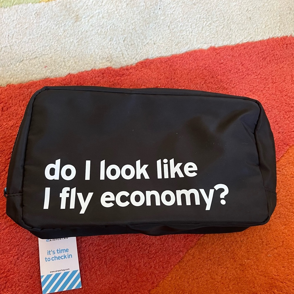 Black Toiletry Bag with White 'Do I Look Like I Fly Economy?' Text